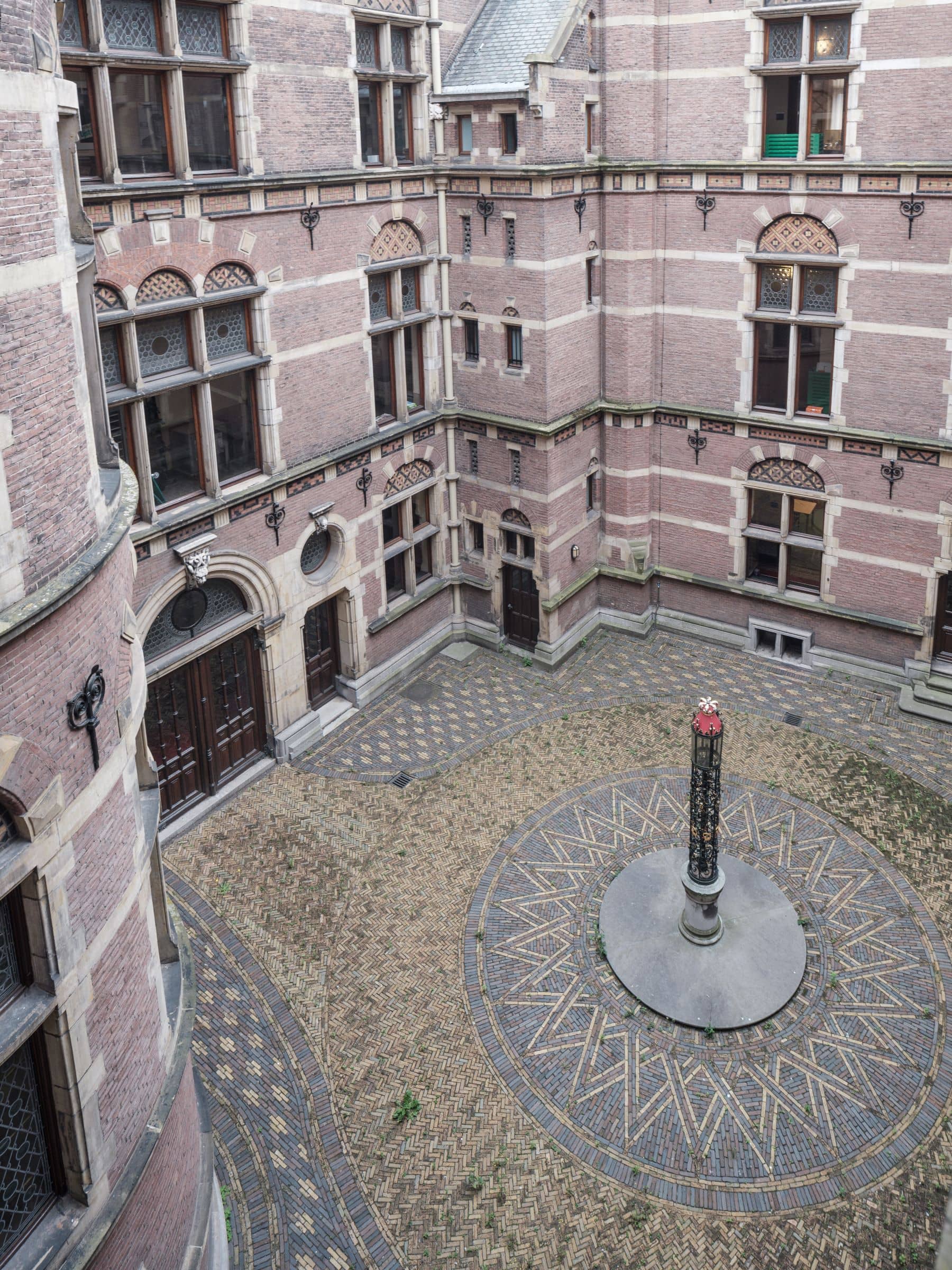 Binnenplaats van gebouw J waar vroeger de koetsen konden keren met in het midden een zuil met lantaarn