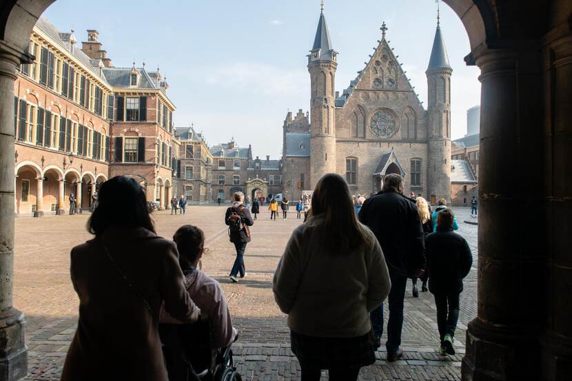 Mensen lopend door ingangspoort Binnenhof